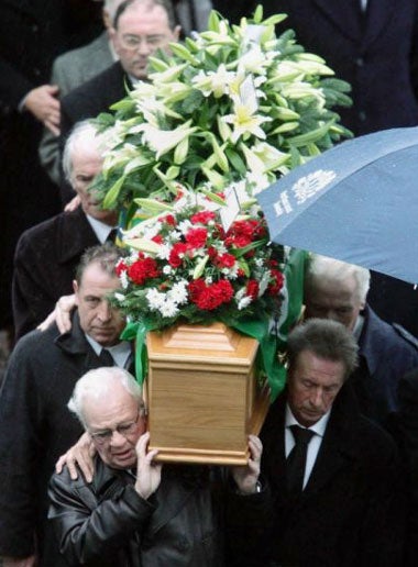 Pallbearers, including Denis Law, carry Best's coffin in to Stormont