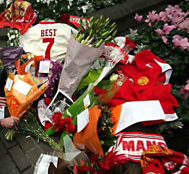 Floral and football tributes are placed outside the London hospital where Best died