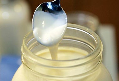 Thick cream that has risen to the top of a jar of fresh raw milk