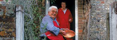 Antonio Carluccio and his wife, Priscilla, outside their ancient cottage in Hampshire