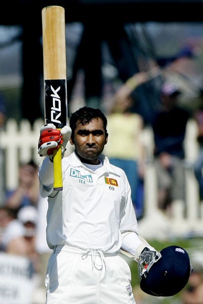 Sri Lankan batsman Mahela Jayawardene waves his bat upon reaching his century (AP)