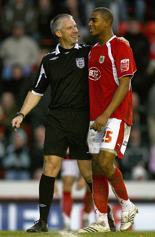 Marvin Elliott, who volleyed in Bristol City's opening goal, shares a joke with the referee