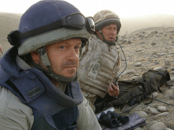 Theatre of war: Ross Kemp hunkers down on a rocky outcrop in Afghanistan where he and his team earned the respect of real hard men in the field © PA