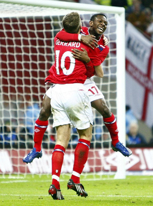 Shaun Wright-Phillips celebrates with captain Steven Gerrard after scoring England's winner at Wembley