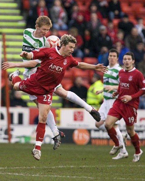 Barry Robson battles with Aberdeen's Chris Maguire during a rare outing for Celtic