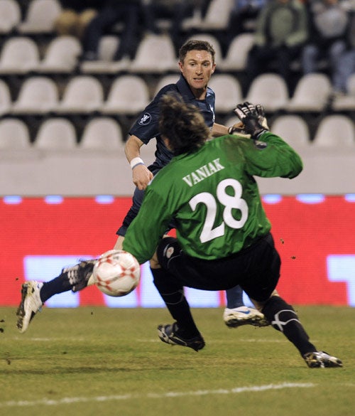 Robbie Keane flicks the ball over the Slavia goalkeeper to give Tottenham a 2-0 lead in the first leg of their Uefa Cup tie
