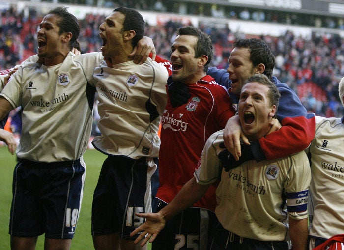 Barnsley captain Brian Howard (right) celebrates with his team-mates after the captain's last-minute goal earned the visitors an incredible 2-1 victory