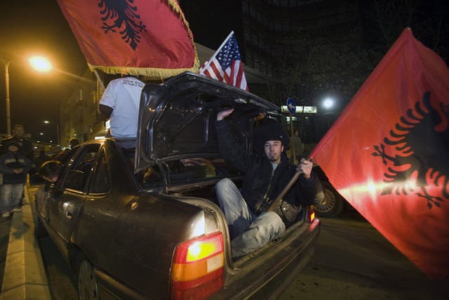 Ethnic Albanians carrying US and Albanian flags celebrate in the center of Kosovo's capital Pristina