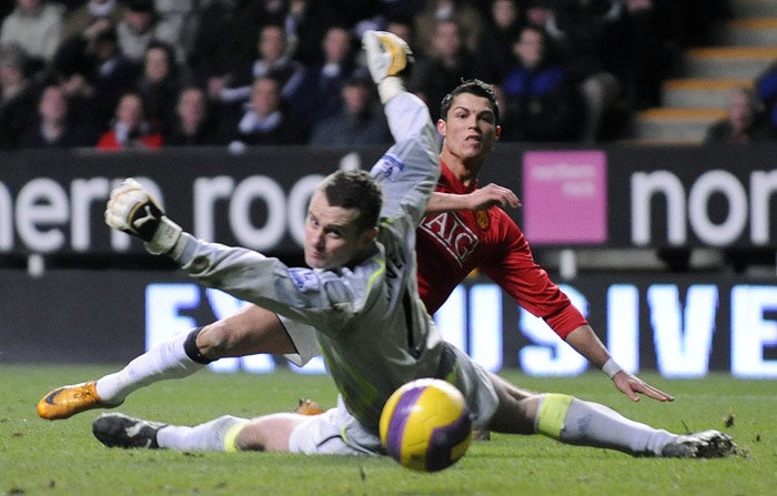 Newcastle goalkeeper Shay Given is helpless to prevent Ronaldo sliding in Manchester United's second goal