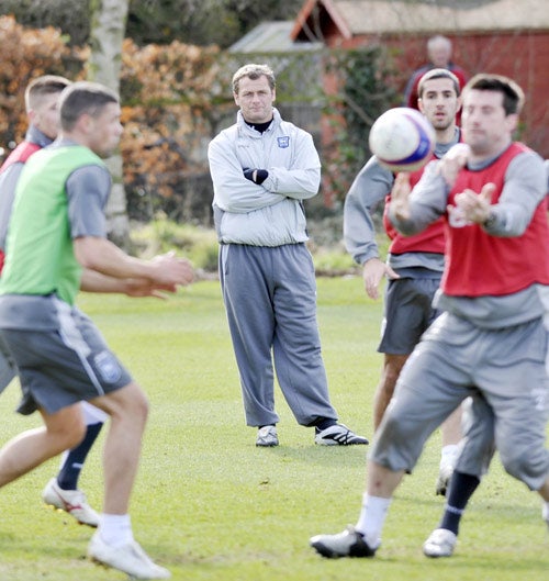 Magilton supervises an Ipswich training session yesterday. 'I said on the first day I wasn't going to mollycoddle anybody, but if they gave me everything, I would respond in kind,' he says