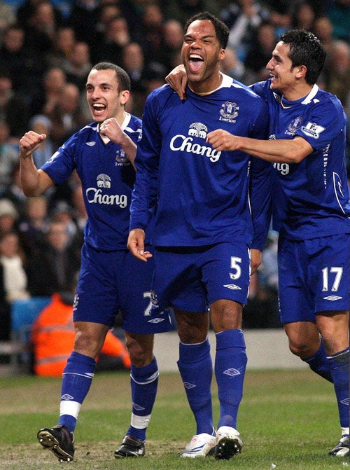 Joleon Lescott celebrates with Tim Cahill (right) and Leon Osman (left) after heading home Everton'ssecond goal in the 2-0 victory at Manchester City on Monday
