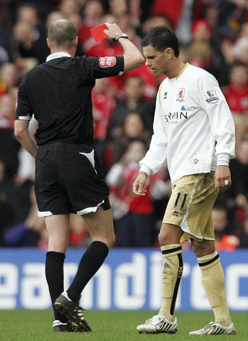 Aliadiere is shown a red card by the referee after lashing out at Anfield
