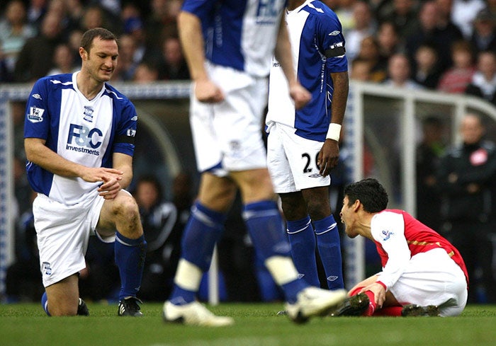 Taylor looks at Eduardo da Silva after the challenge that left the Arsenal striker facing nine months out injured