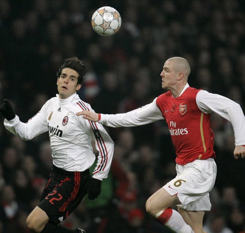 Senderos (right) battles with Kaka during the first leg tie at the Emirates