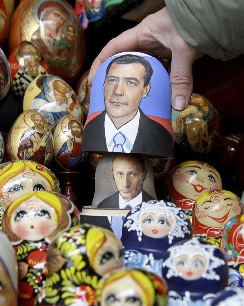 Medvedev on the outside shell of a 'matryoshka' doll at a St Petersburg stall, with Putin beneath