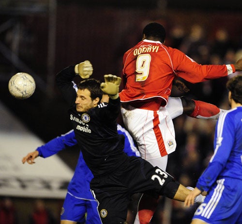 Odejayi rises above Chelsea goalkeeper Carlo Cudicini to score the winning goal on a famous night for Barnsley