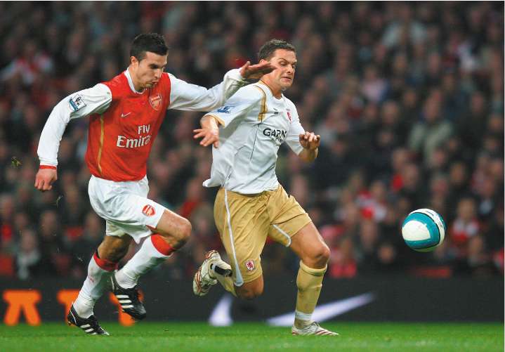 Robin van Persie, on his return to the Arsenal line-up, tangles with Middlesbrough's Luke Young