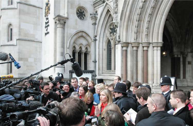Heather Mills talks to members of the media as she leaves the Royal Courts of Justice