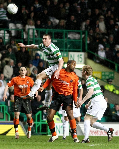 Celtic's Scott Brown wins a header during the recent 0-0 home draw with Dundee United. The midfielder believes his team can close a three-point gap on leaders Rangers in what remains of the SPL season