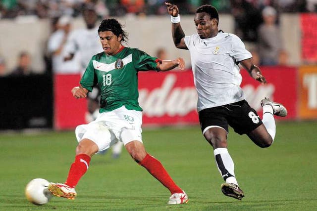 Ghana's Michael Essien (right) moves in to tackle Mexico's Diego Martinez when the two countries met in Frisco, Texas in 2006, a 1-0 victory for the Mexicans