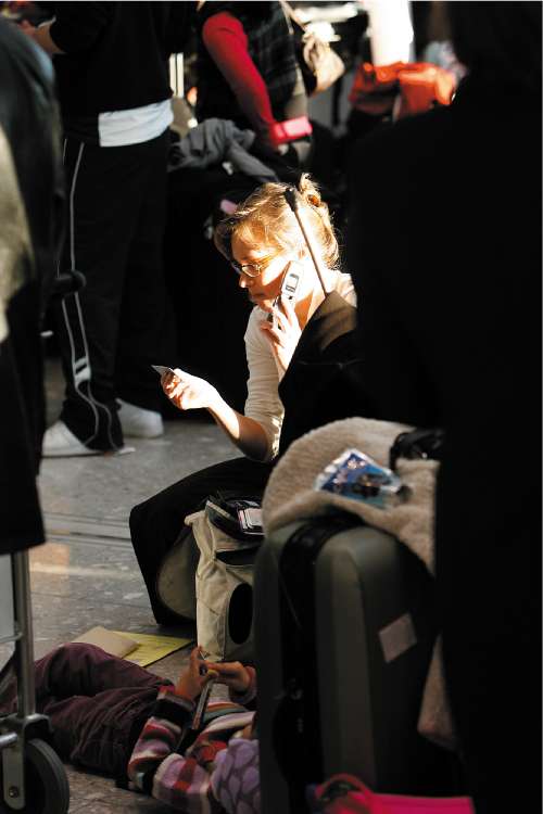 A passenger makes a phone call as she waits to check in at the new Terminal 5 yesterday