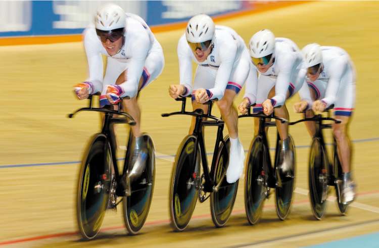 Bradley Wiggins leads the Great Britain men's pursuit team as they set a gold medal-winning world record time of 3min 56.322sec during their victory over Denmark at the Track Cycling World Championships yesterday