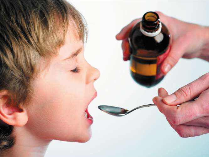 A generic picture of a child being given cough syrup