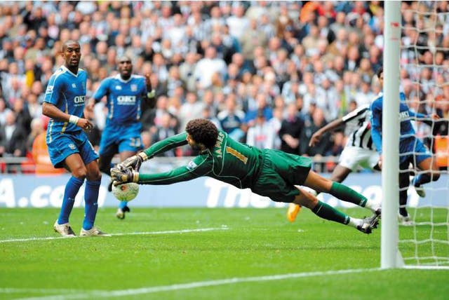 Portsmouth goalkeeper David James makes an athletic dive to keep out another West Bromwich Albion attack