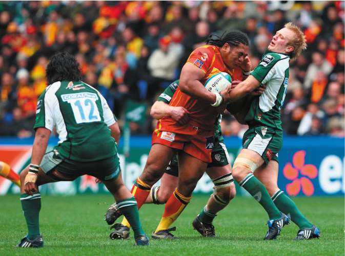 Perpignan No 8 Henry Tuilagi runs into Shane Geraghty, London Irish's replacement fly-half, at the Madejski