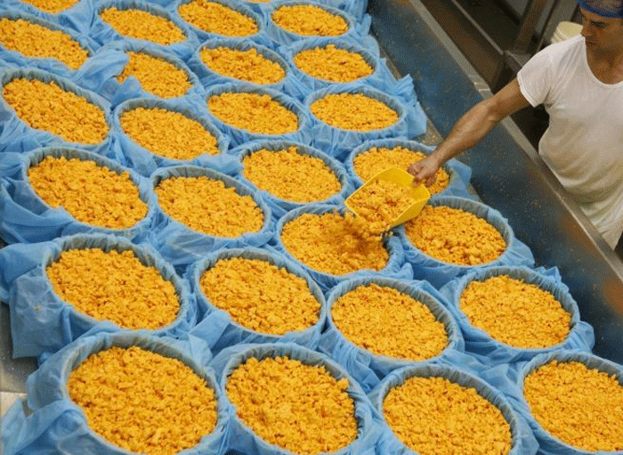 Whey forward: a farm worker prepares the curds as he makes Red Leicester cheese © Reuters