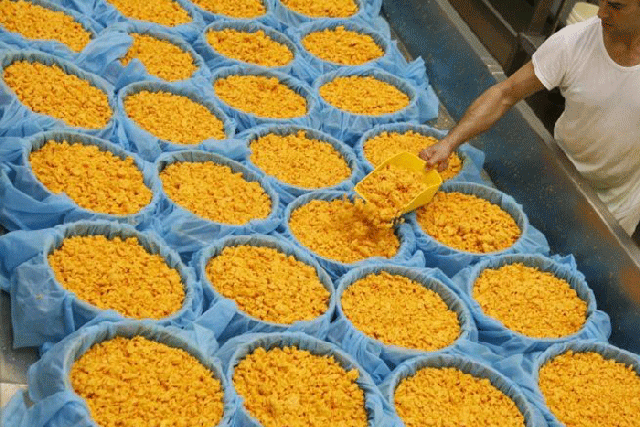 Whey forward: a farm worker prepares the curds as he makes Red Leicester cheese © Reuters