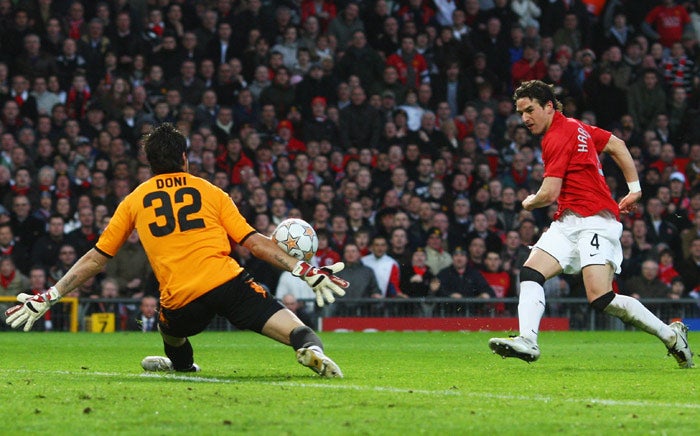 Roma goalkeeper Doni foils a strike by Owen Hargreaves, in an attacking role for Manchester United, at Old Trafford last night