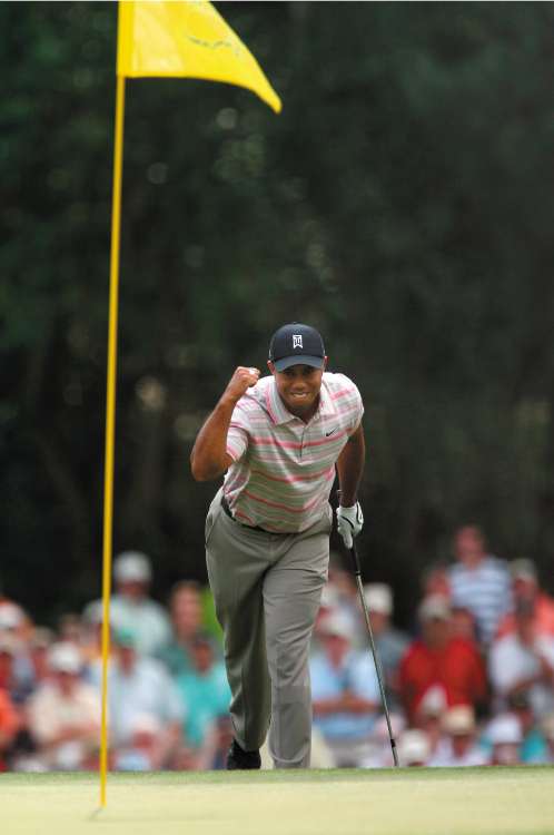 Woods celebrates an eagle on the 15th hole during the first round at Augusta