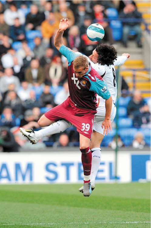 Bolton midfielder Ivan Campo beats Jack Collison of West Ham to the ball