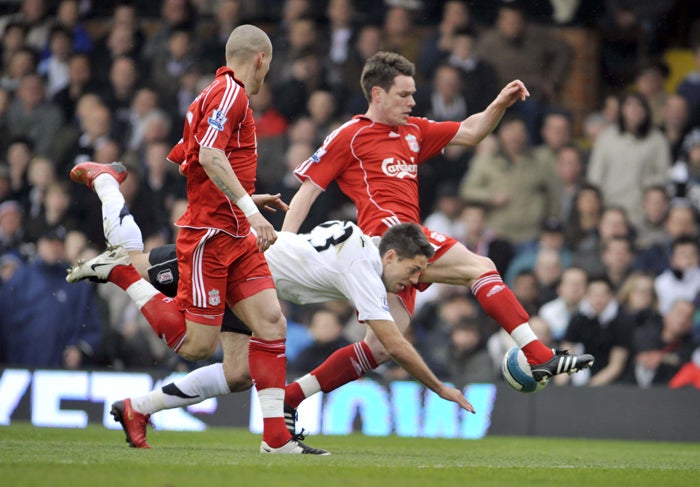Liverpool's Steve Finnan steers the ball away as Clint Dempsey tumbles during a defeat which virtually seals Fulham's fate