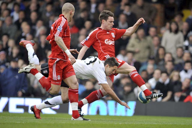 Liverpool's Steve Finnan steers the ball away as Clint Dempsey tumbles during a defeat which virtually seals Fulham's fate