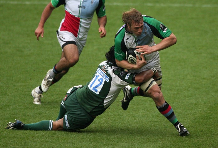 Harlequins flanker Chris Robshaw is tackled by London Irish centre Seilala Mapusua in the Exiles' winat the Madejski Stadium