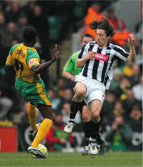 Norwich City's Mo Camara battles for the ball with Robert Koren, the scorer of West Bromwich Albion's first goal