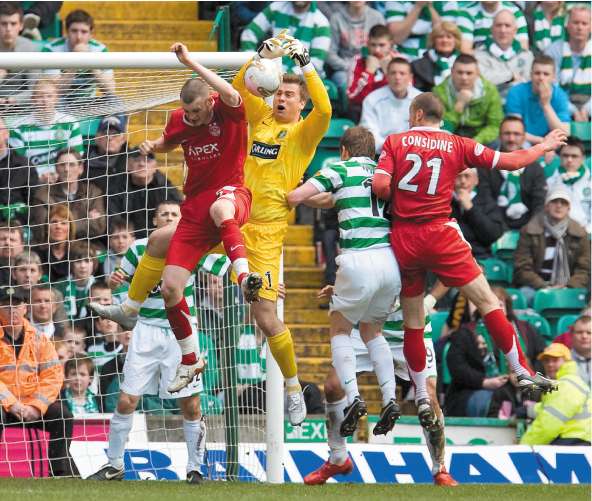 Zander Diamond (left) challenges the Celtic goalkeeper, Artur Boruc, during Saturday's match at Parkhead. The Aberdeen defender had a late goal ruled out