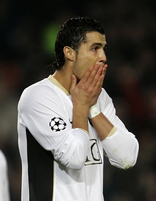 Cristiano Ronaldo reacts after missing a penalty in the third minute against Barcelona last night