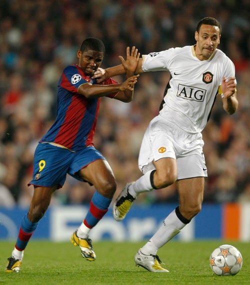 Rio Ferdinand holds off Barcelona's Samuel Eto'o during last night's goalless draw at the Nou Camp