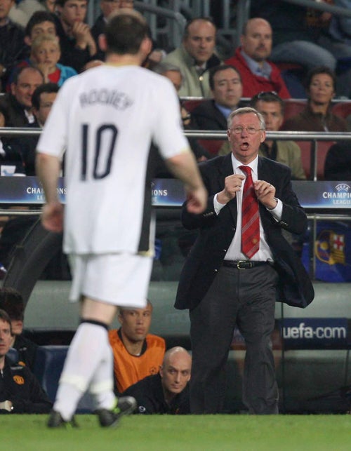 Sir Alex Ferguson, issues instructions to striker Wayne Rooney during his side'suninspiring 0-0 Champions League draw with Barcelona at the Nou Camp