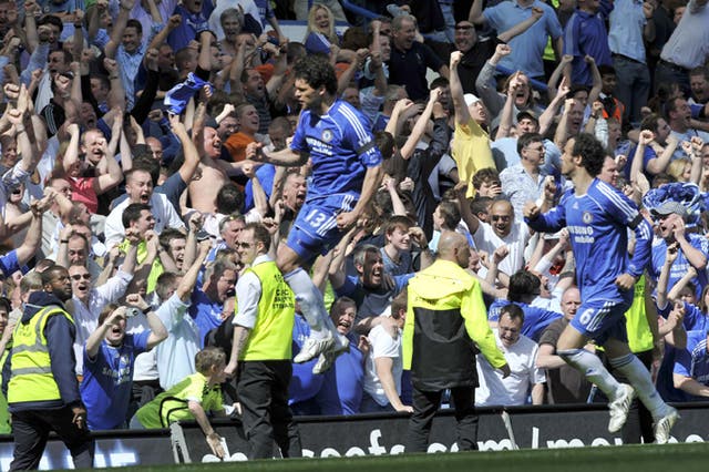 Chelsea's Michael Ballack celebrates after his second goal, a late penalty, earns the Blues a 2-1 victory over Manchester United to keep it tight at the top
