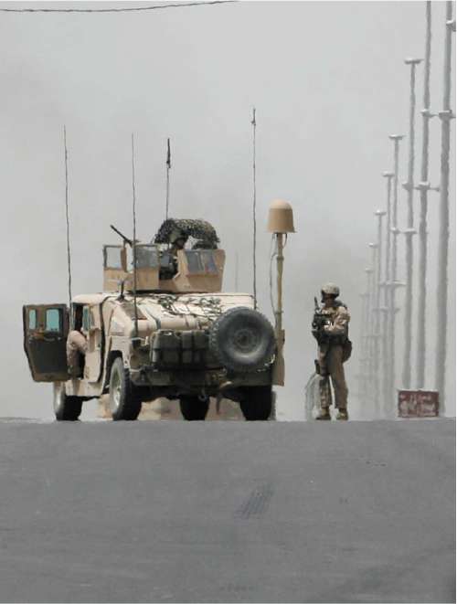 US troops secure the site of an attack on their convoy in Basra