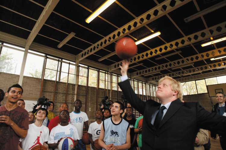 Boris Johnson shoots hoops during a visit to Stockwell Park High School