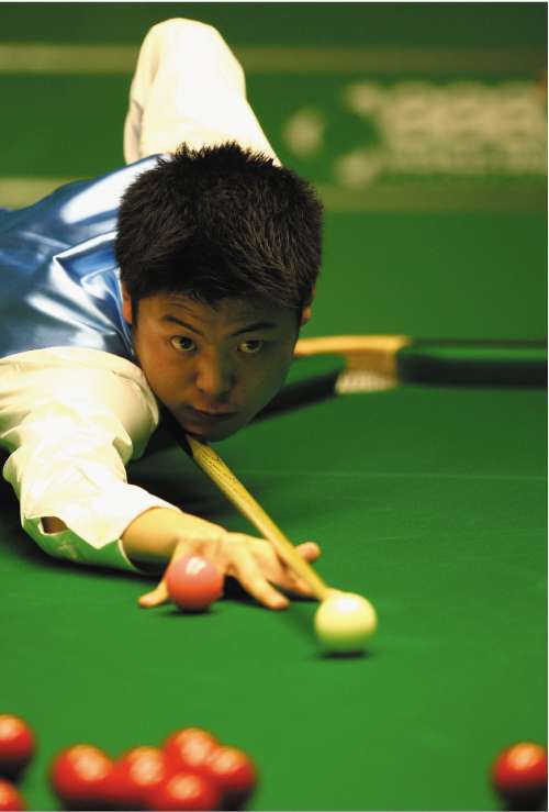 Liang Wenbo lines up a shot against Ronnie O'Sullivan during the World Championship quarter-finals