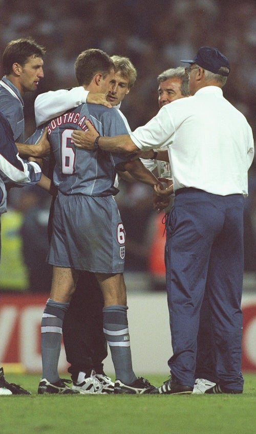Gareth Southgate is consoled after his missed penalty contributed to semi-final defeat by Germany 1996