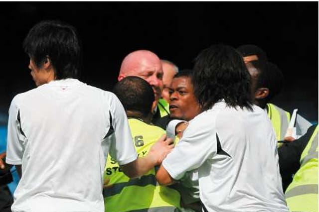Manchester United's Patrice Evra at the centre of the melee that took place after his sides defeat at Chelsea