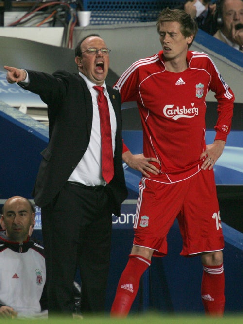Peter Crouch prepares to be sent on by his manager, Rafael Benitez, as an impact substitute. The England striker's effectiveness in this role at Liverpool this season helps explain his limited first-team chances