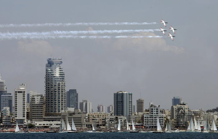 Israeli Air Force planes fly over the skyline of Tel Aviv during Independence Day celebrations yesterday